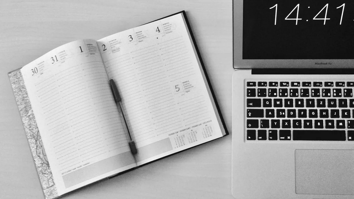 Open planner calendar beside a laptop clock showing how long SEO takes