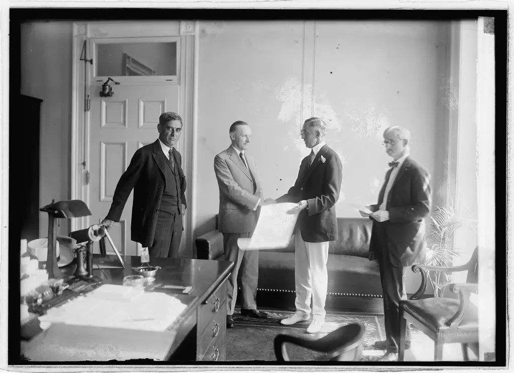B2B team reviewing a marketing pipeline dashboard in a conference room