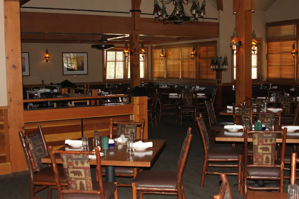 Busy restaurant dining room with guests during evening service