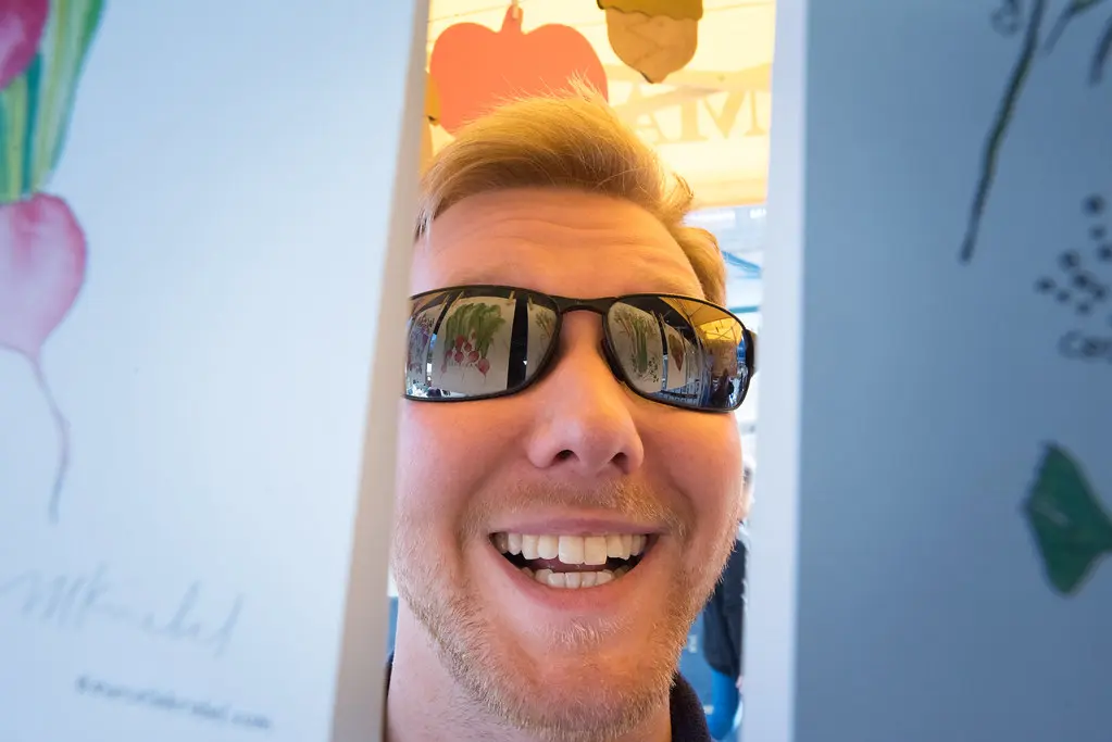 Small business owner standing at the counter of a local shop