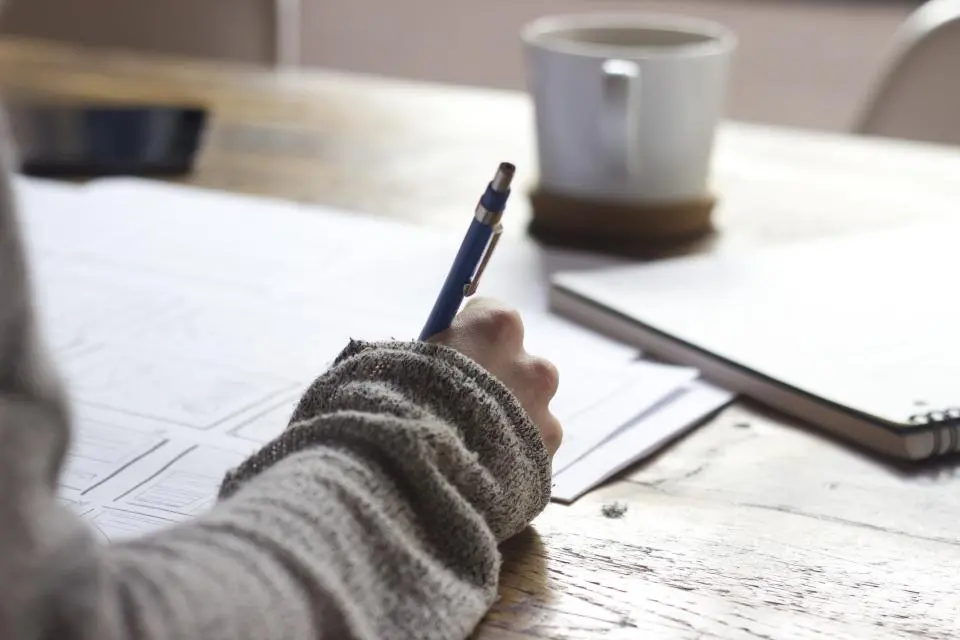 Writer planning an SEO content strategy with keyword research on screen